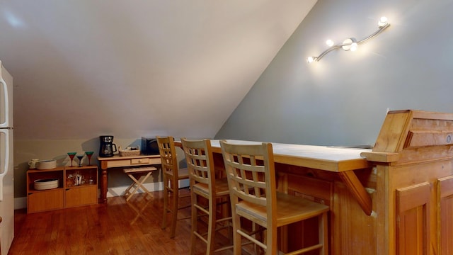 dining area featuring dark hardwood / wood-style floors and lofted ceiling