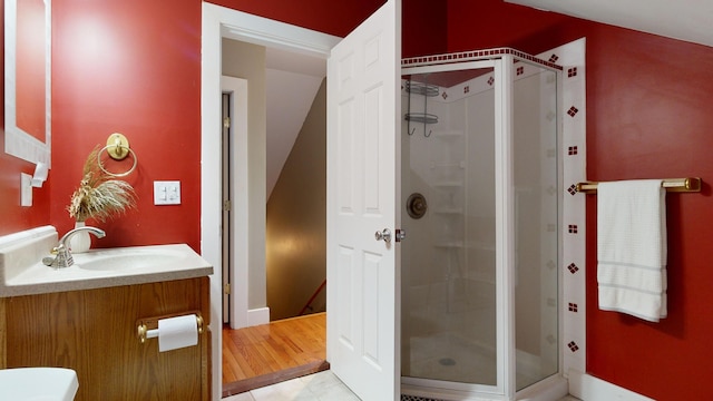 bathroom featuring hardwood / wood-style floors, vanity, and an enclosed shower