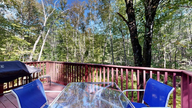 wooden terrace with a grill