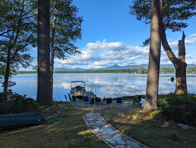 property view of water with a mountain view and a boat dock