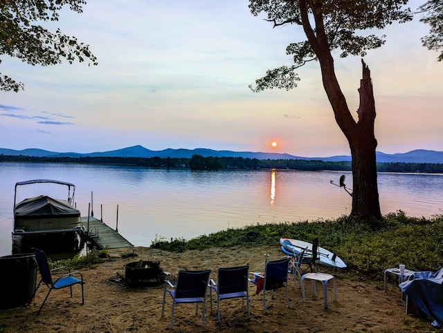 property view of water with a mountain view and a boat dock