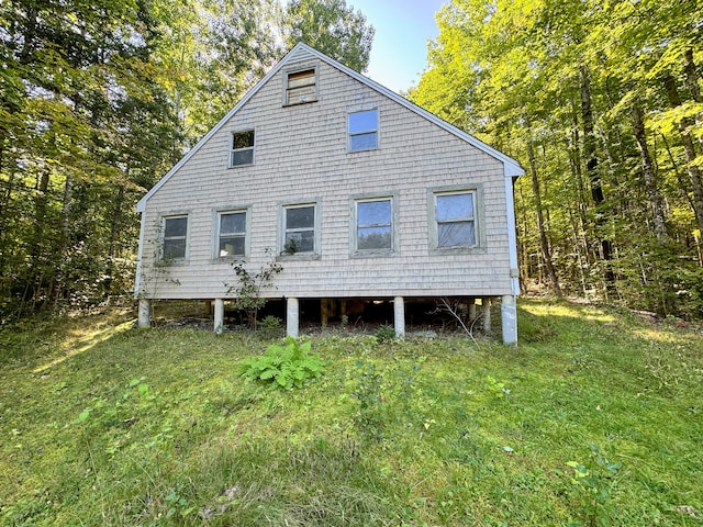 rear view of house featuring a lawn