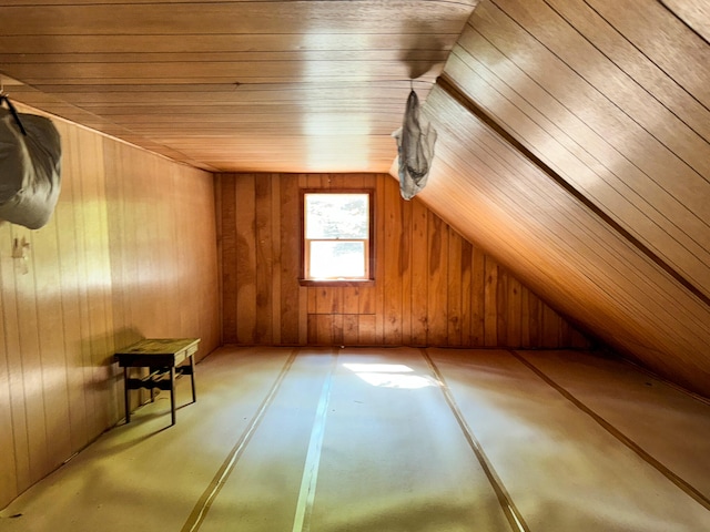 additional living space with wooden walls, wooden ceiling, and vaulted ceiling