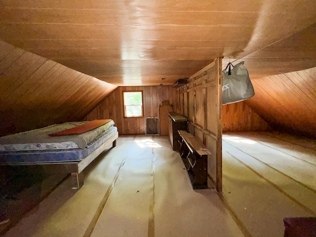 interior space featuring wood walls, wood ceiling, and vaulted ceiling