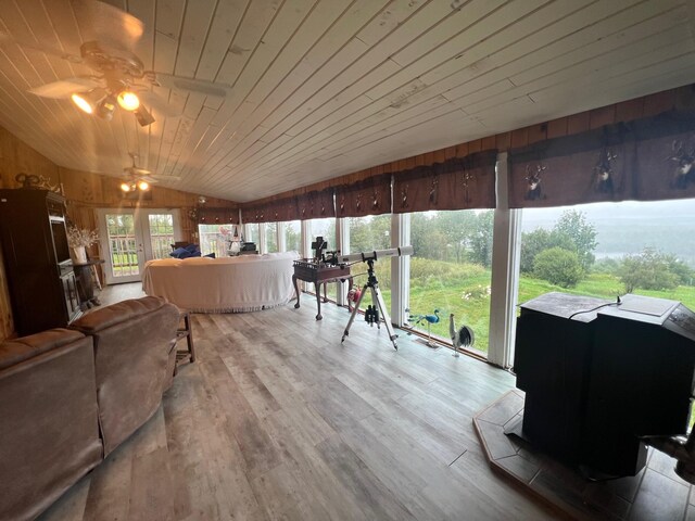 sunroom featuring ceiling fan, wood ceiling, and lofted ceiling