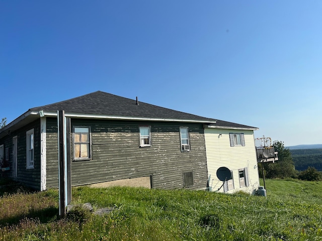 rear view of property featuring a yard