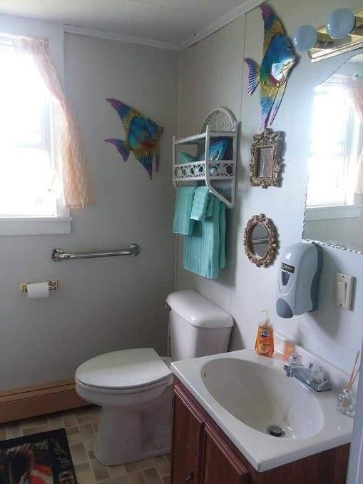 bathroom featuring a healthy amount of sunlight, vanity, and toilet