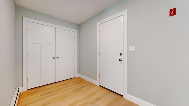 entryway with a baseboard radiator and light wood-type flooring