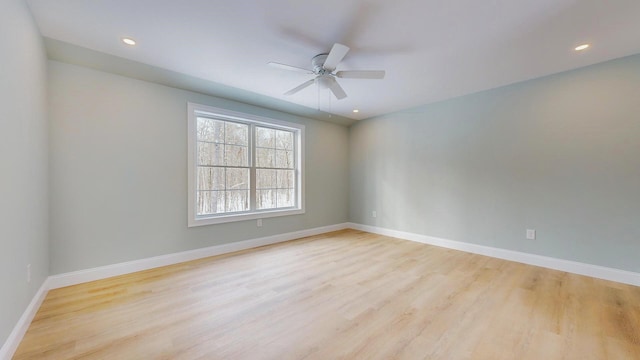 unfurnished room with ceiling fan and light wood-type flooring