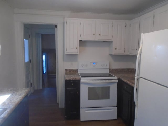 kitchen with dark wood-type flooring, white cabinets, and white appliances