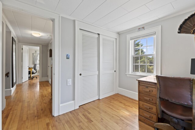 home office featuring crown molding and light hardwood / wood-style flooring