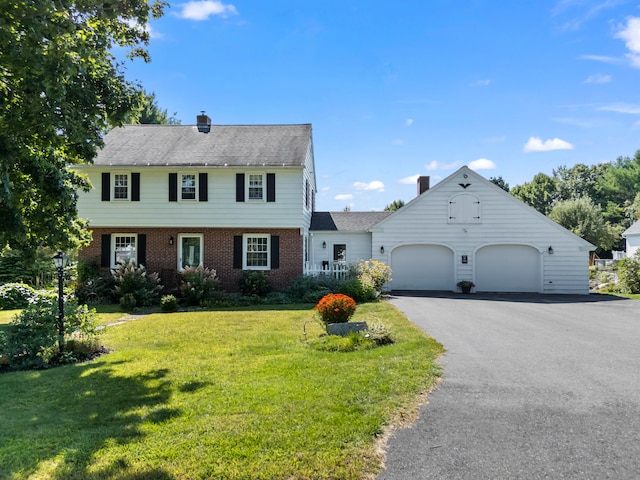 view of front of property with a front lawn and a garage