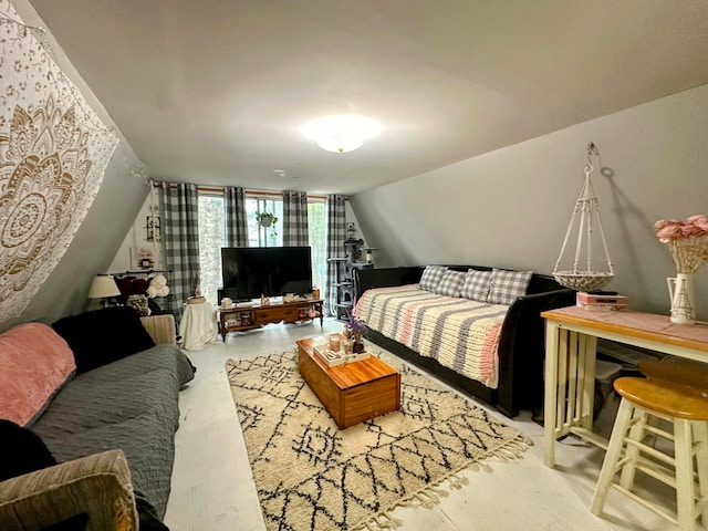 bedroom with vaulted ceiling and concrete floors