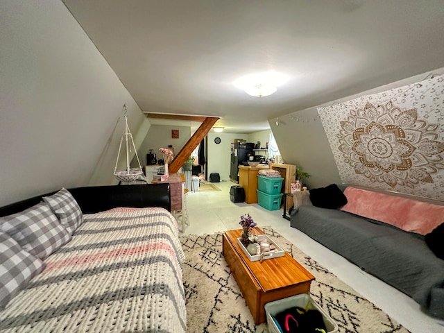 bedroom with black fridge