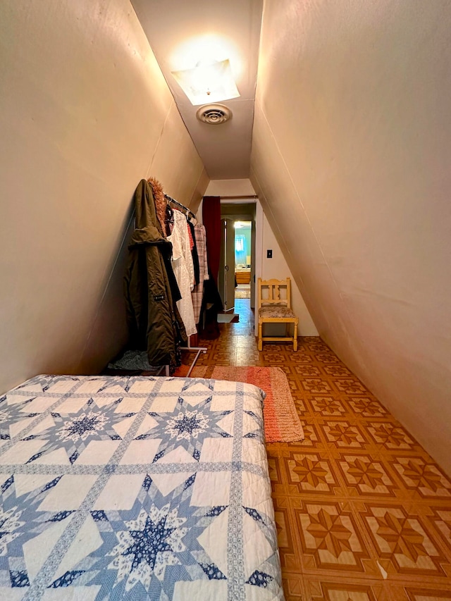 unfurnished bedroom with lofted ceiling