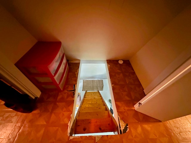 staircase featuring vaulted ceiling