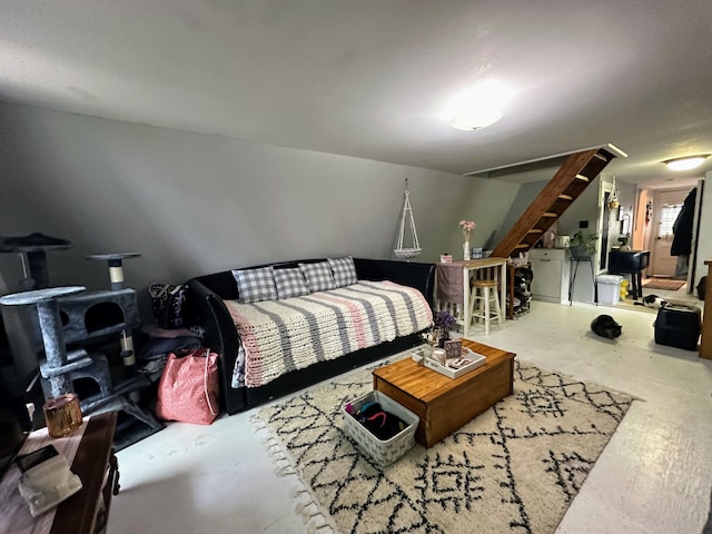 bedroom featuring concrete flooring