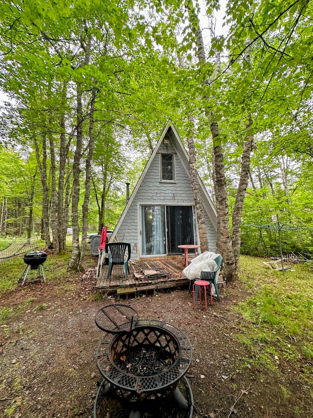 rear view of house featuring a deck