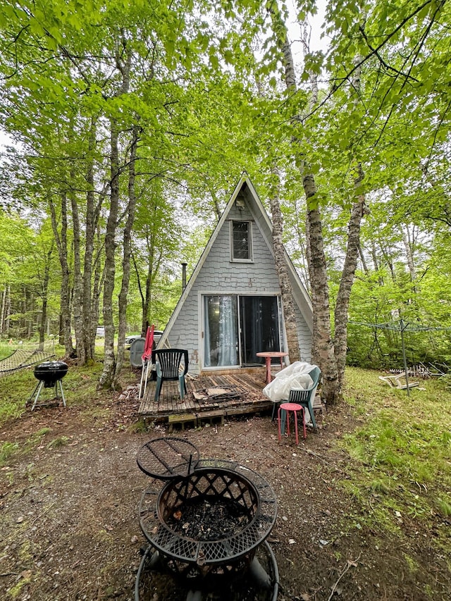 32 Dinsmore Ln, Whiting, ME 04691 - rear view of house featuring an outdoor fire pit and a wooden deck