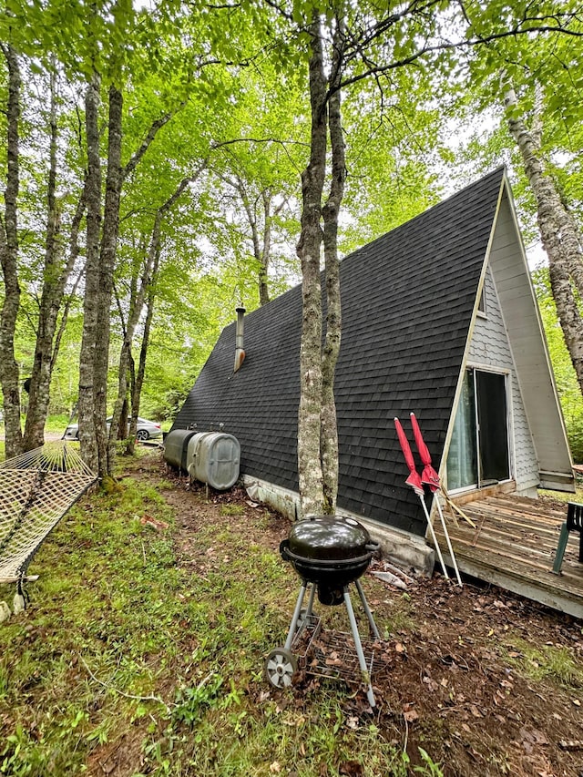 32 Dinsmore Ln, Whiting, ME 04691 - view of property exterior with a shingled roof and a deck