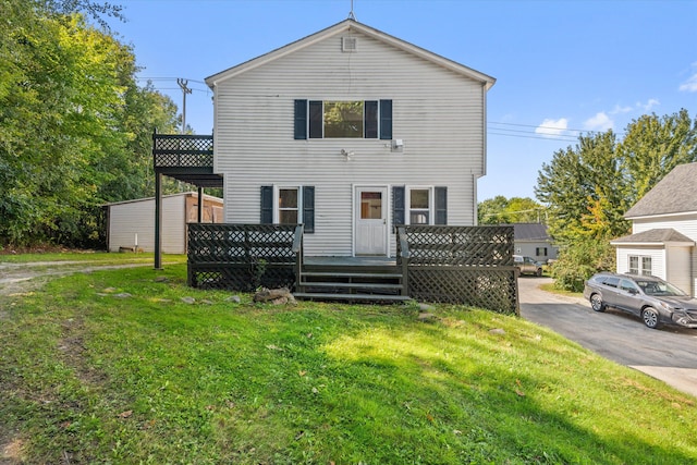 view of front property with a front lawn and a deck