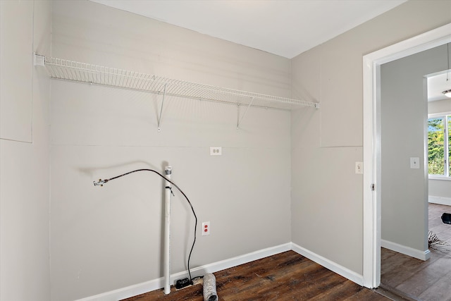 clothes washing area with dark hardwood / wood-style floors