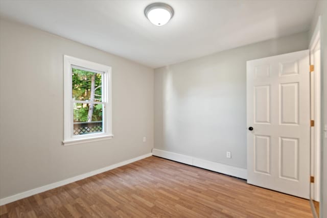 spare room with light hardwood / wood-style flooring