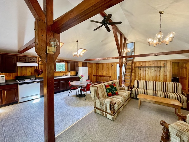 living room featuring beamed ceiling, wood walls, sink, high vaulted ceiling, and ceiling fan with notable chandelier