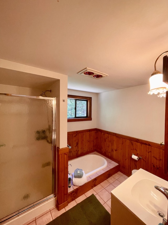 bathroom featuring shower with separate bathtub, vanity, and tile patterned floors