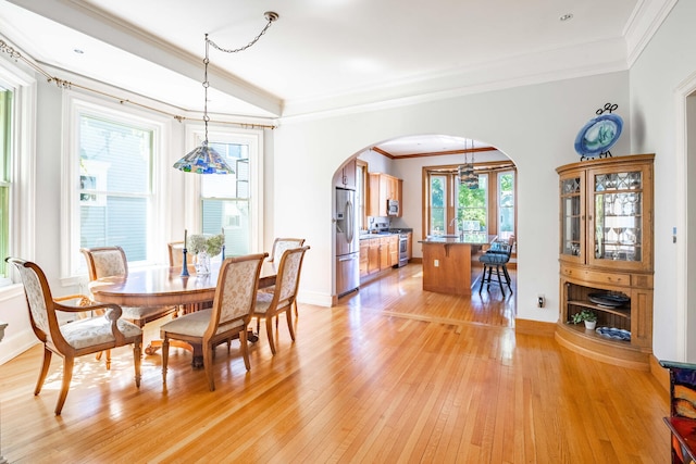 dining area featuring ornamental molding and light hardwood / wood-style floors