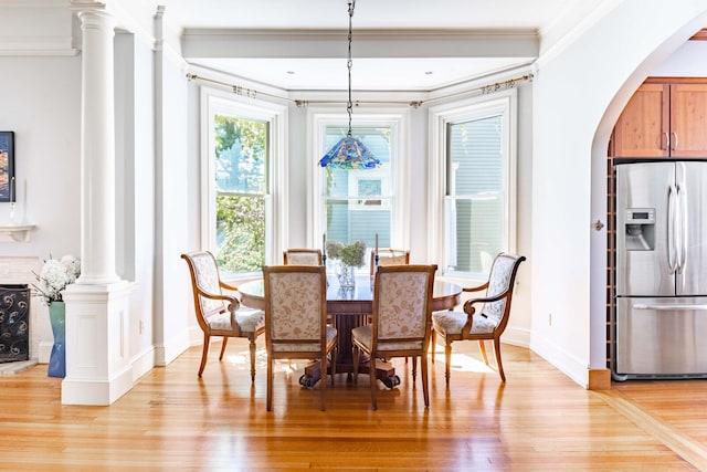 dining area featuring light hardwood / wood-style floors and ornamental molding