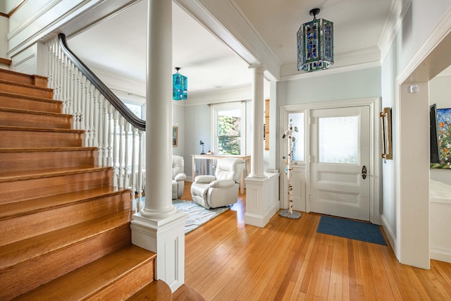 foyer entrance with crown molding and light wood-type flooring