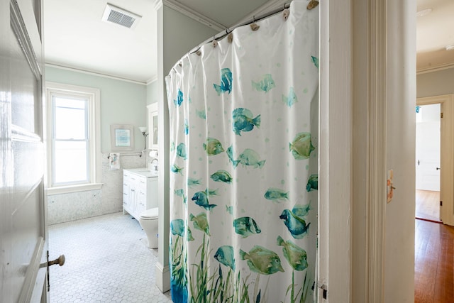 bathroom with a shower with shower curtain, toilet, vanity, crown molding, and hardwood / wood-style flooring