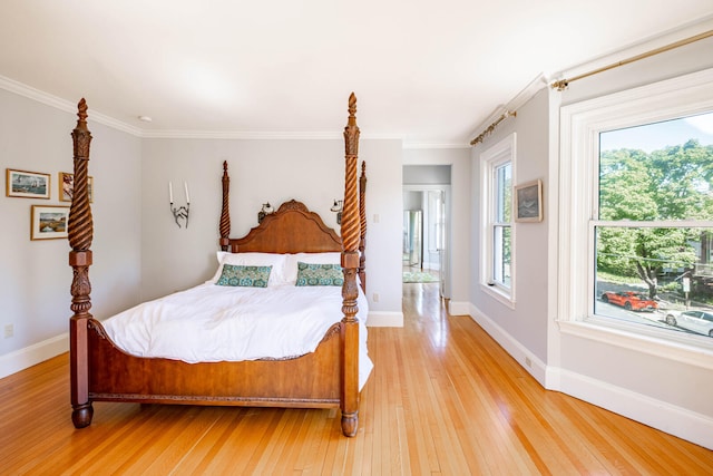 bedroom featuring crown molding and hardwood / wood-style flooring