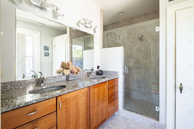 bathroom with vanity, tile patterned flooring, and walk in shower