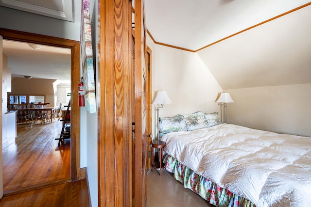 bedroom with lofted ceiling and hardwood / wood-style flooring