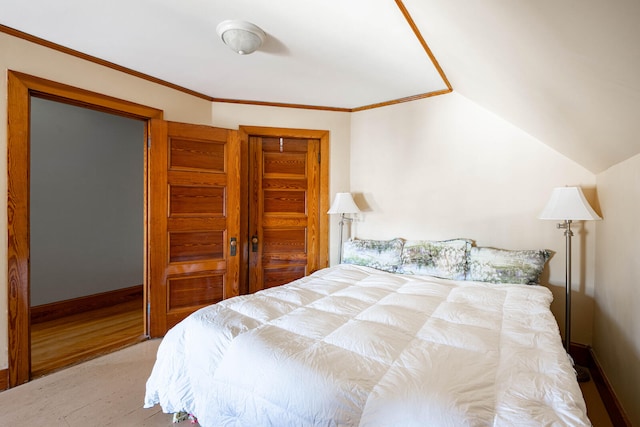 bedroom featuring lofted ceiling, crown molding, and wood-type flooring