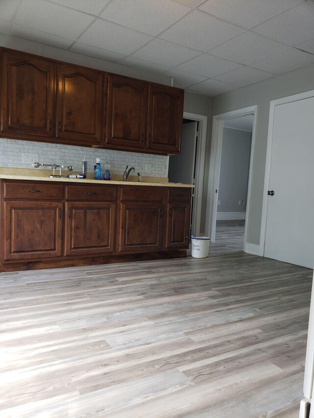 kitchen with light hardwood / wood-style flooring and decorative backsplash