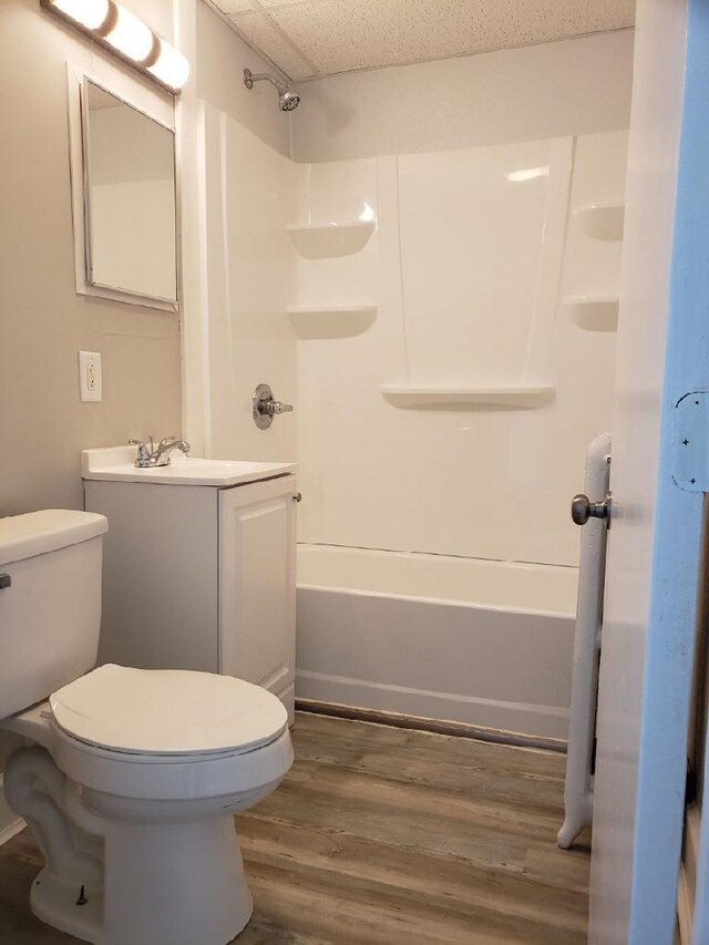 full bathroom featuring tub / shower combination, hardwood / wood-style flooring, vanity, and toilet