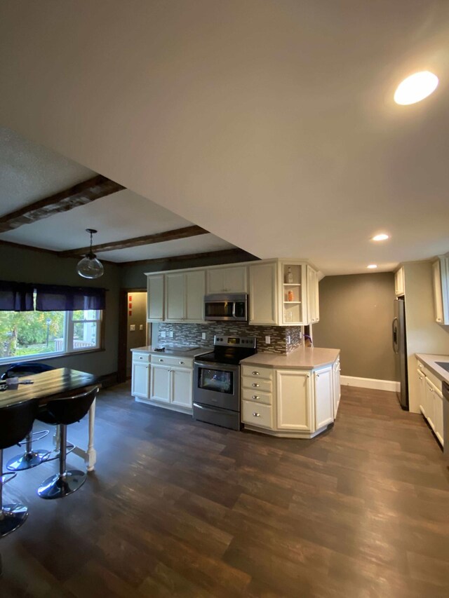 kitchen with dark hardwood / wood-style floors, hanging light fixtures, stainless steel appliances, decorative backsplash, and white cabinetry