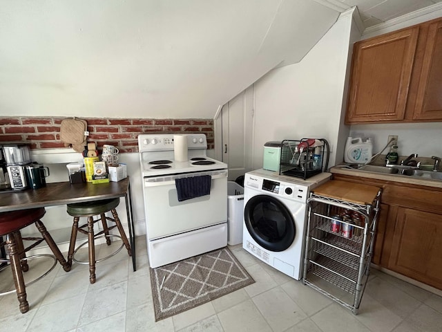 kitchen featuring white electric range oven, a sink, washer / dryer, brick wall, and brown cabinets