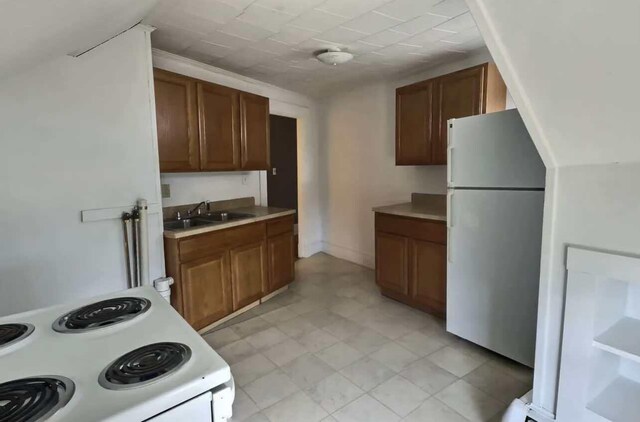 kitchen featuring white appliances and sink