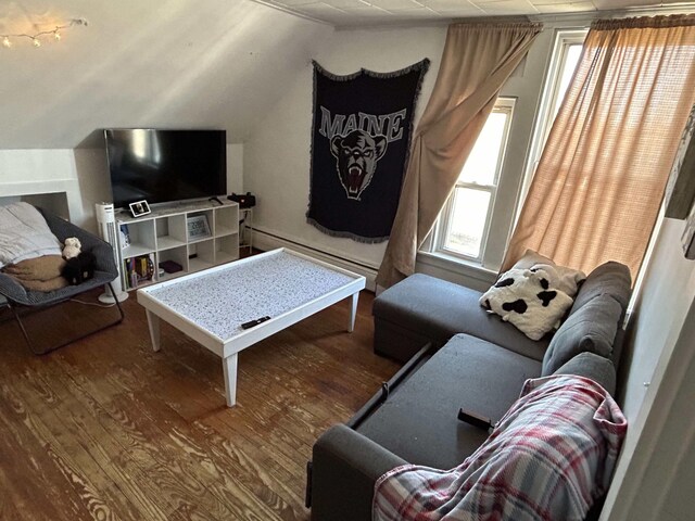 living room with a baseboard heating unit, wood-type flooring, and vaulted ceiling