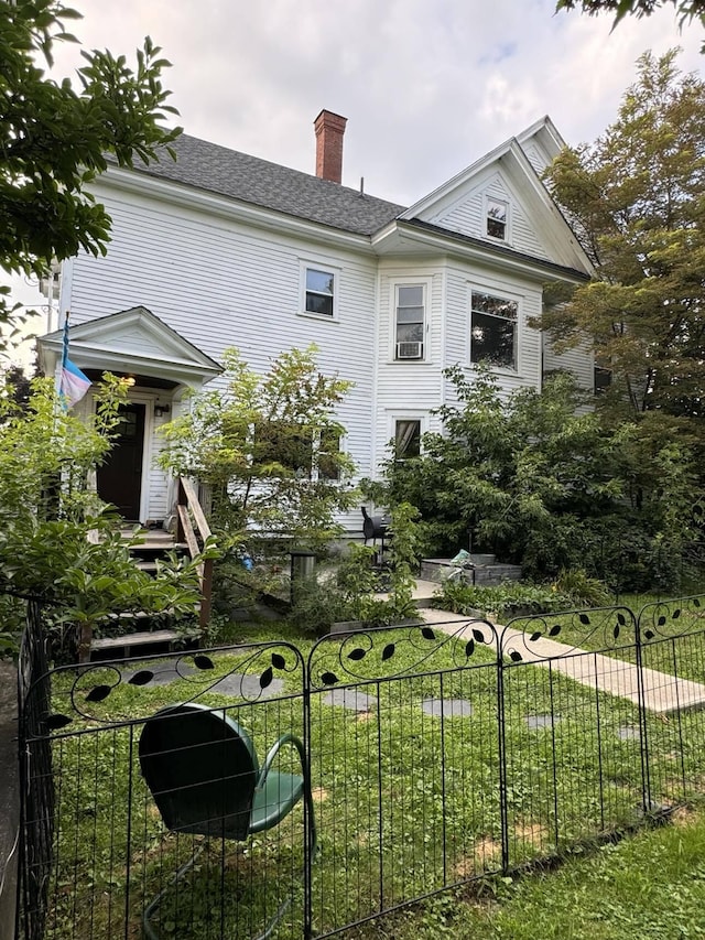 rear view of property with a lawn