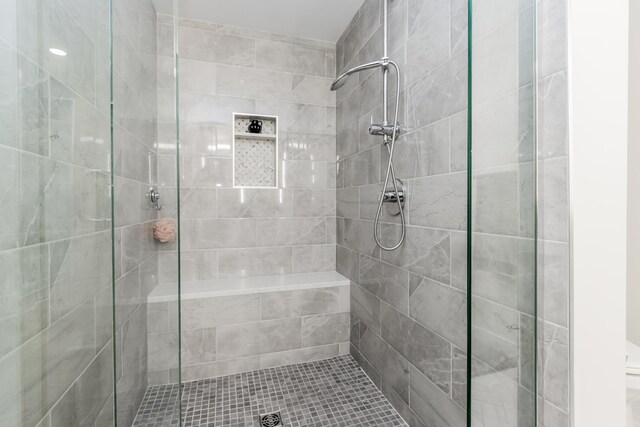 bathroom with a shower with shower door