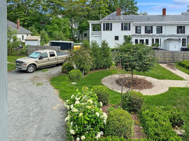 view of yard with fence and driveway