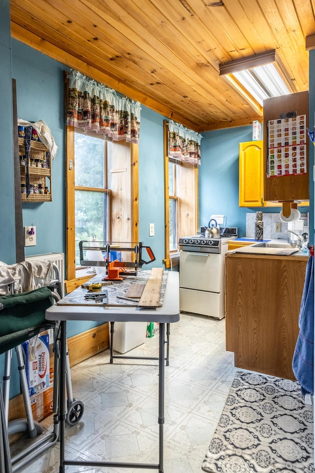 kitchen with light floors, wooden ceiling, white electric range, and a sink