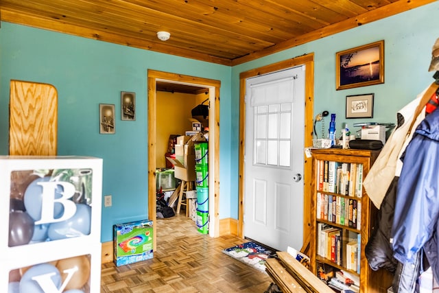 foyer entrance with wood ceiling and baseboards
