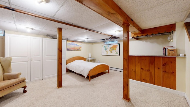 bedroom featuring carpet floors, a paneled ceiling, and baseboard heating