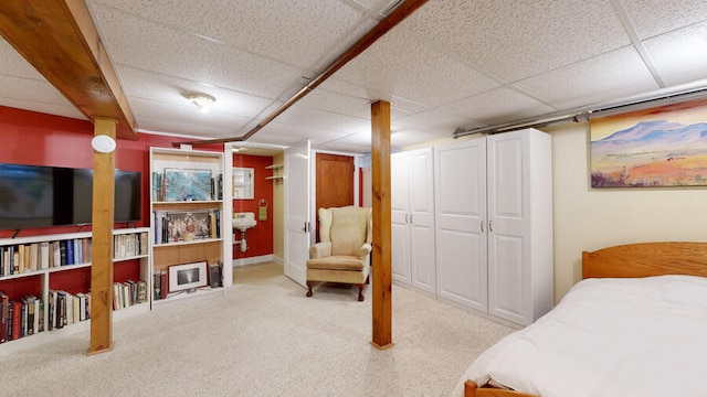 carpeted bedroom with a paneled ceiling